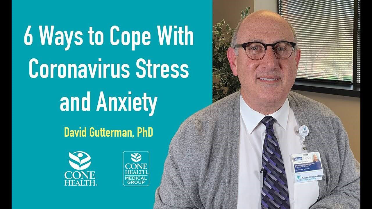 The image features a person sitting at a desk with text overlaying the image. The text reads  6 WAYS TO COPE WITH CORONAVIRUS STRESS AND ANXIETY  and includes a logo for Cone Healthcare.